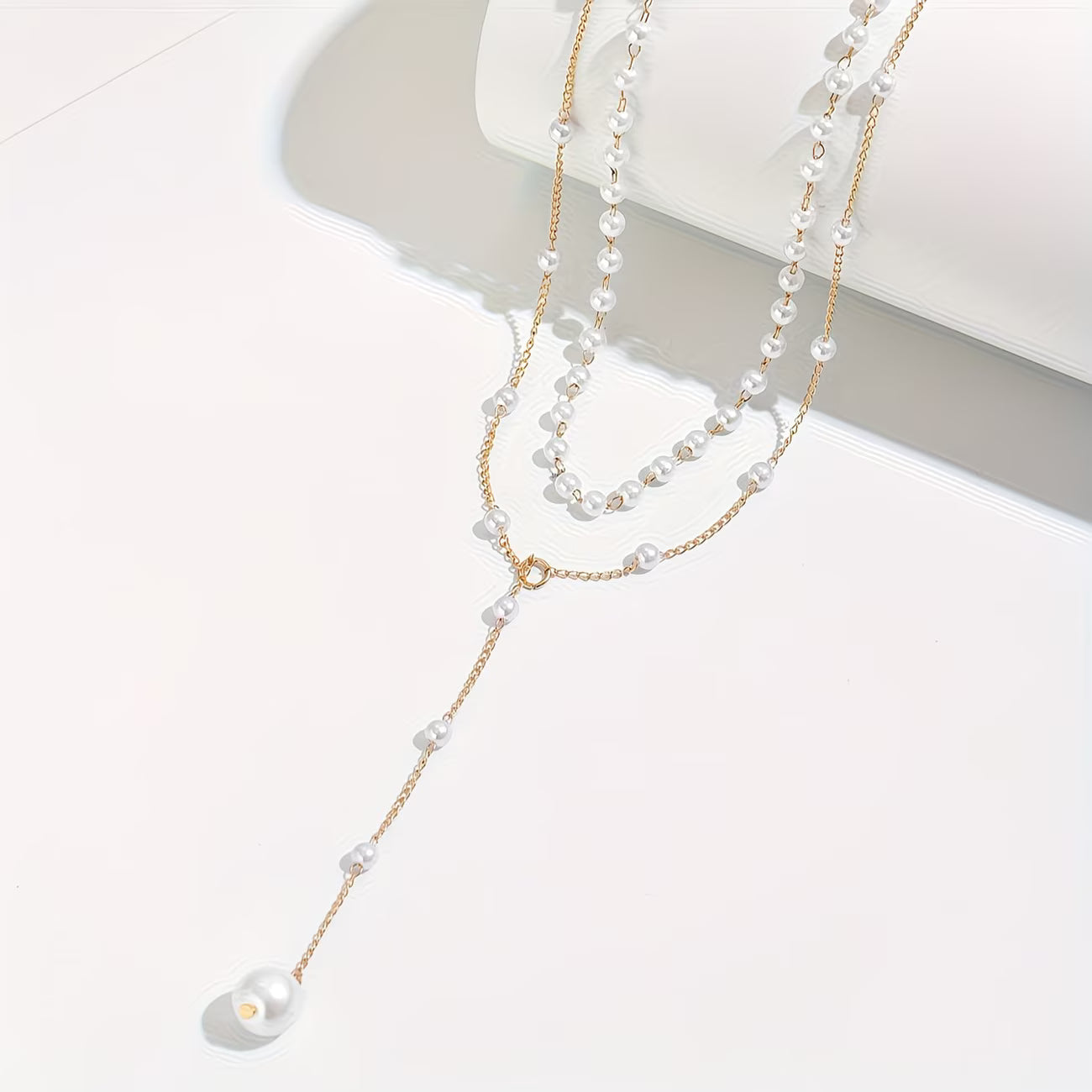 Collier de perles graduées de la collection de bijoux Danoir Paris, élégant et sophistiqué, avec perles blanches brillantes.