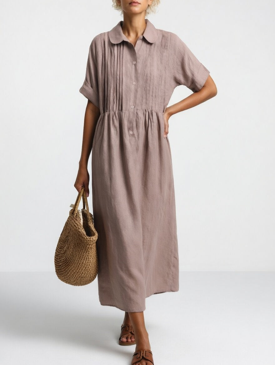 Robe chemise fluide d'été Lysandra™ de Danoir Paris, tissu léger blanc avec détails élégants, portée décontractée.