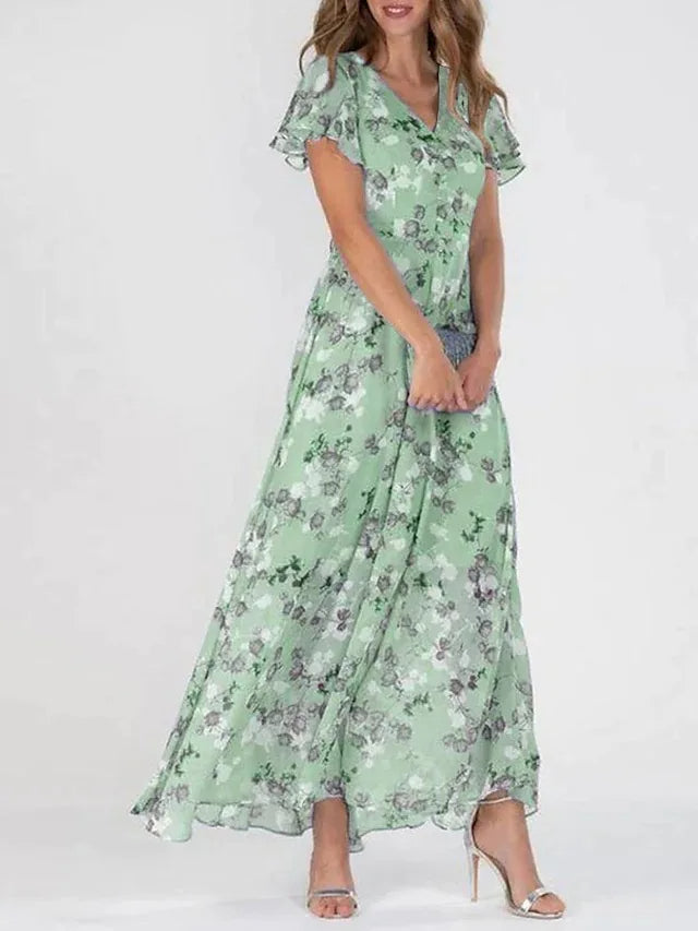 Robe maxi fleurie élégante Danoir Paris, en tissu léger, avec motif floral coloré, portée en occasion spéciale ou décontractée.