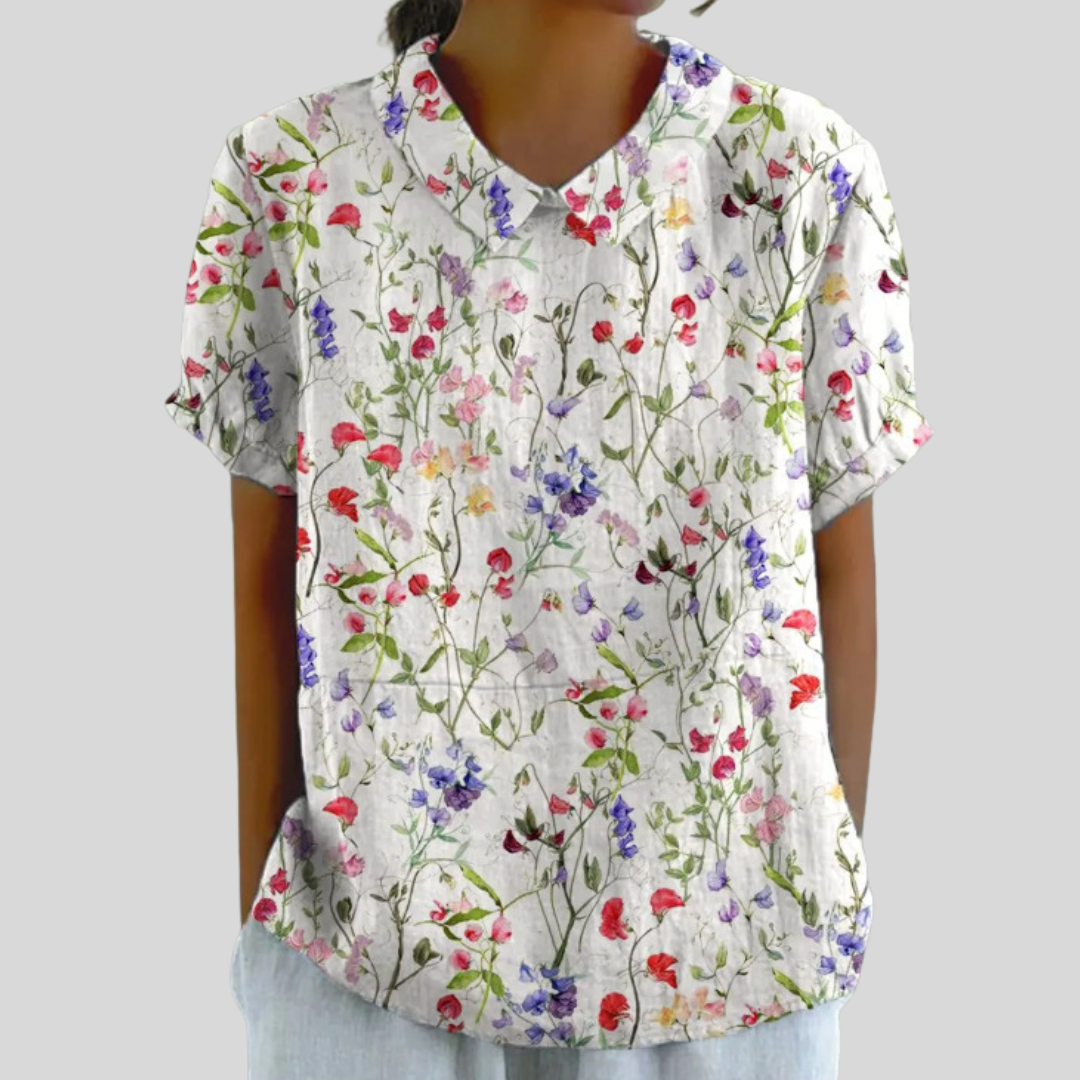 Blouse Clarélia™ de Danoir Paris avec motifs floraux délicats en blanc, vue de face, tissu léger et élégant.