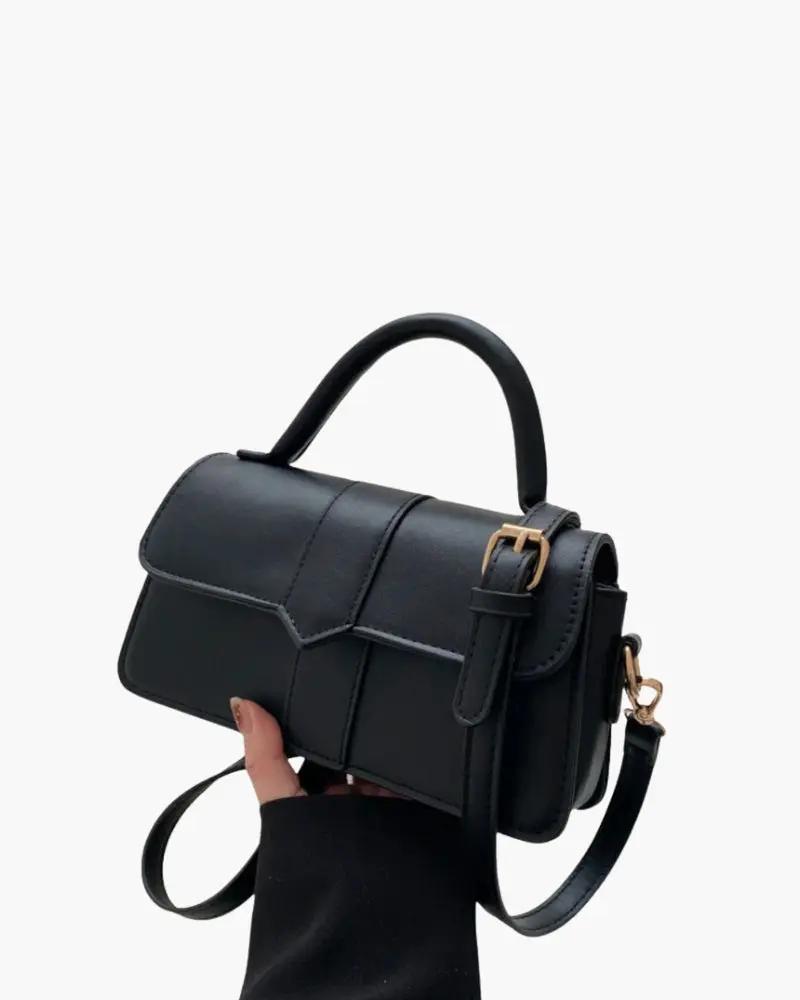 Sac à main The Paris en cuir marron de Danoir Paris, avec poignées et fermeture élégante.
