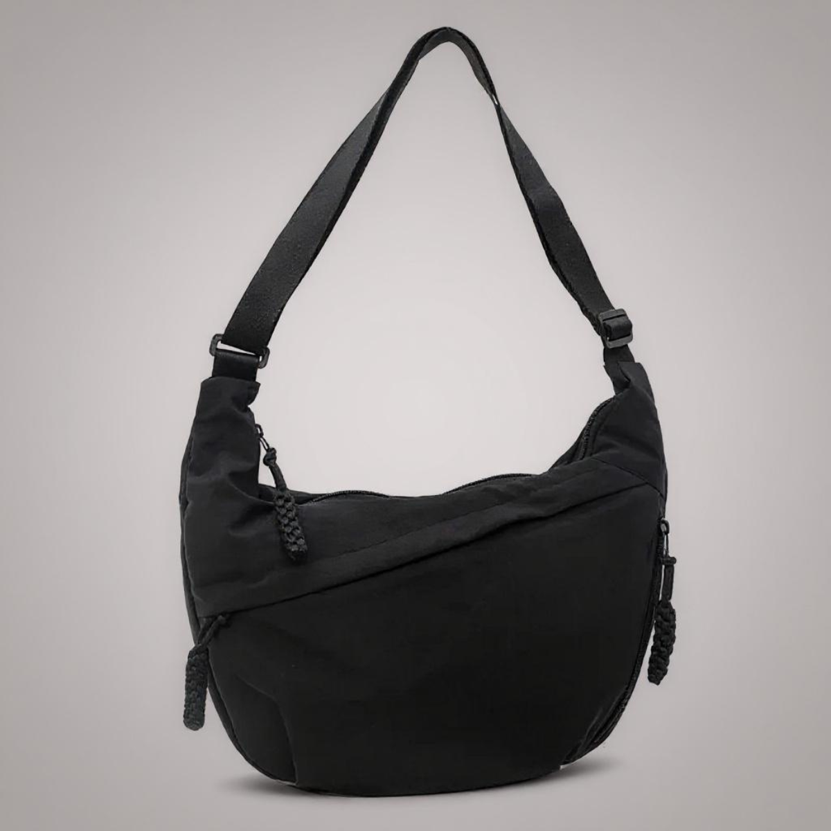 Sac à bandoulière noir Aria de Danoir Paris, en cuir synthétique avec poches et détails élégants visibles sur l'image.