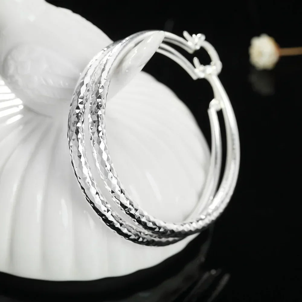 Boucles d'oreilles en argent sterling Danoir Paris avec design élégant, visibles sur un fond clair.