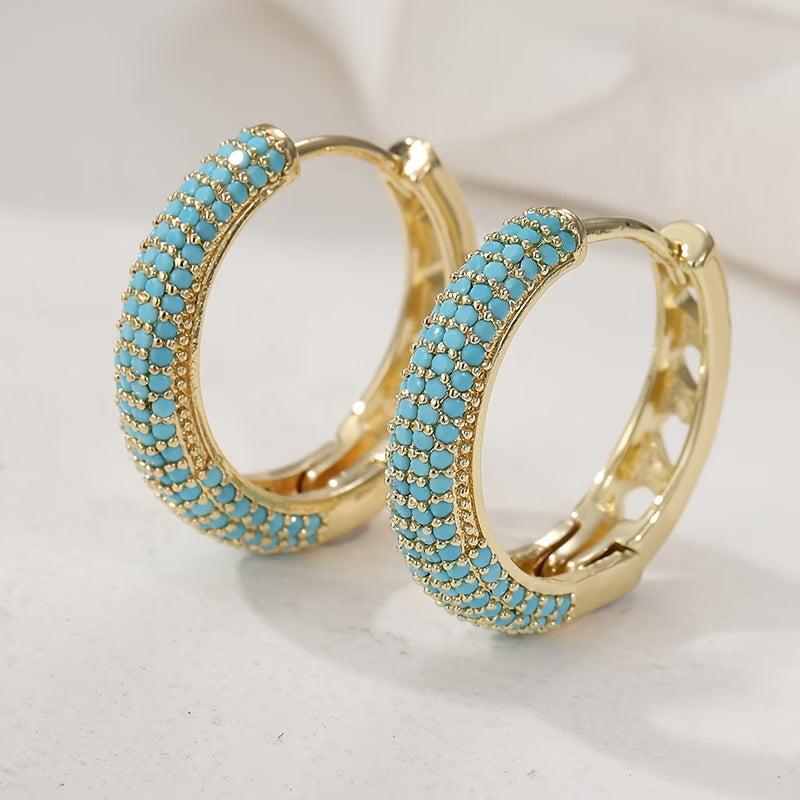 Boucles d'oreilles turquoise charmantes de la marque Danoir Paris, en argent avec pierre colorée, visibles sur une image claire.
