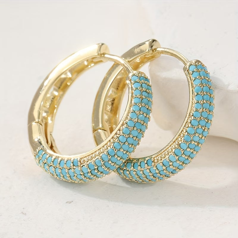 Boucles d'oreilles turquoise charmantes de la marque Danoir Paris, avec perles colorées et design élégant visible sur l'image.