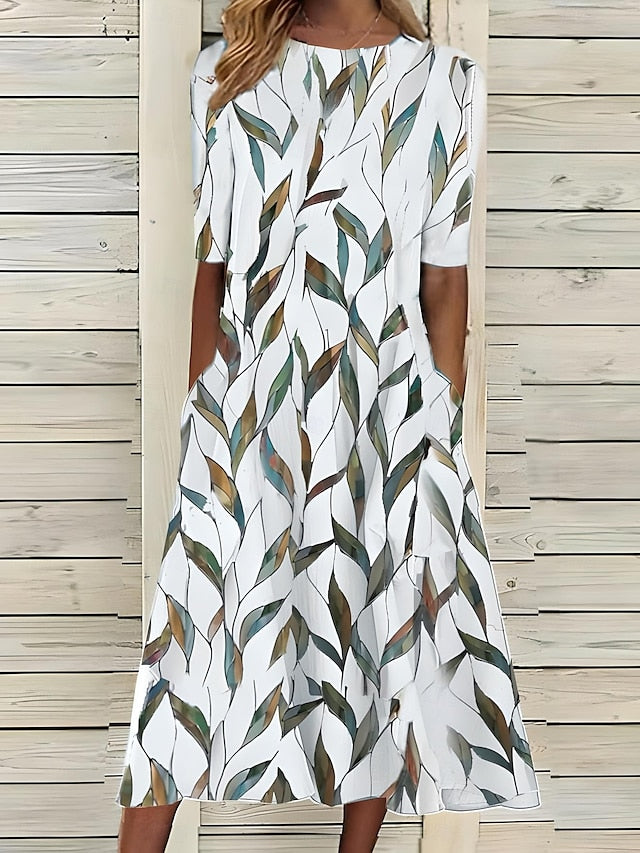 Robe Carlee Coastal Bloom de Danoir Paris en tissu bleu foncé, avec motif floral et coupe élégante.