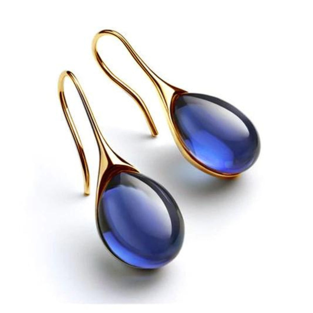 Boucles d'oreilles pendantes Danoir Paris en or bleu avec cristaux élégants et raffinés.