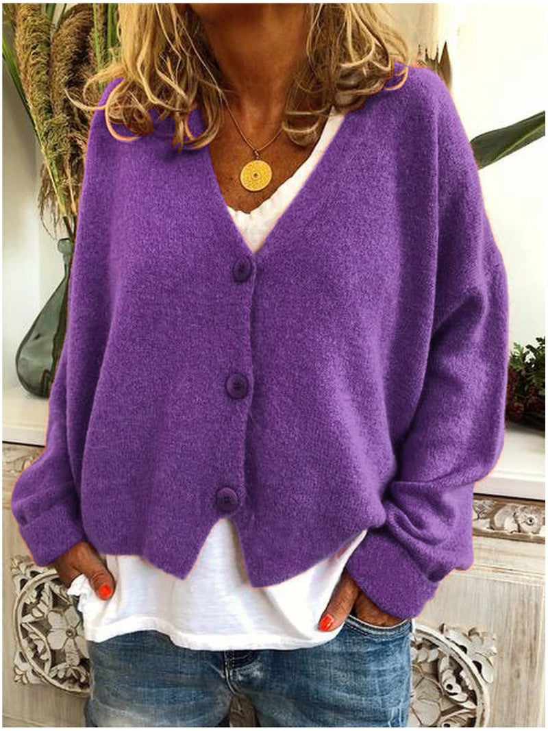 Cardigan tricoté élégant Scarlett de Danoir Paris en orange, vêtement féminin à manches longues et finition soignée.