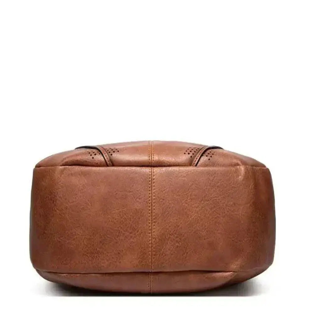 Sac vintage intemporel Danoir Paris Anya en gris, sac polyvalent en cuir élégant avec poignée et fermeture métallique.