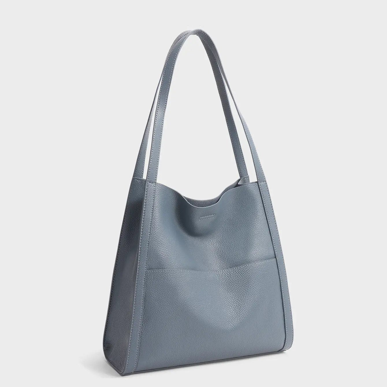 Sac à main en cuir marron Elise de Danoir Paris, élégant et sophistiqué, avec poignées et détails en cuir visible dans l'image.