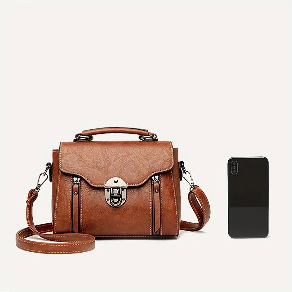 Sac à main rétro-chic Luna de Danoir Paris en maroquin marron avec poignées et détails élégants.