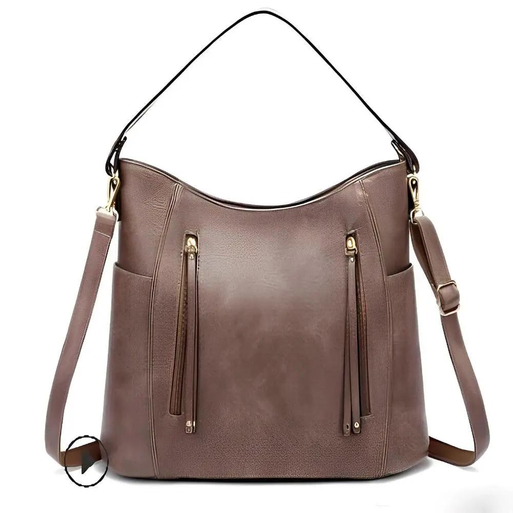 Sac à bandoulière vintage Danoir Paris Tessa en cuir marron, design classique et intemporel, avec bandoulière ajustable.
