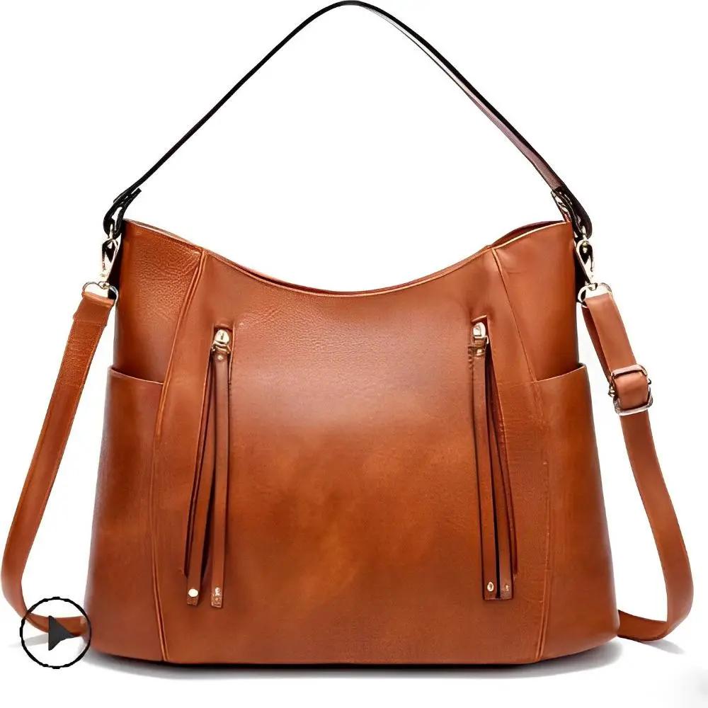 Sac à bandoulière vintage Tessa de Danoir Paris, en cuir marron, avec design classique et détails élégants.