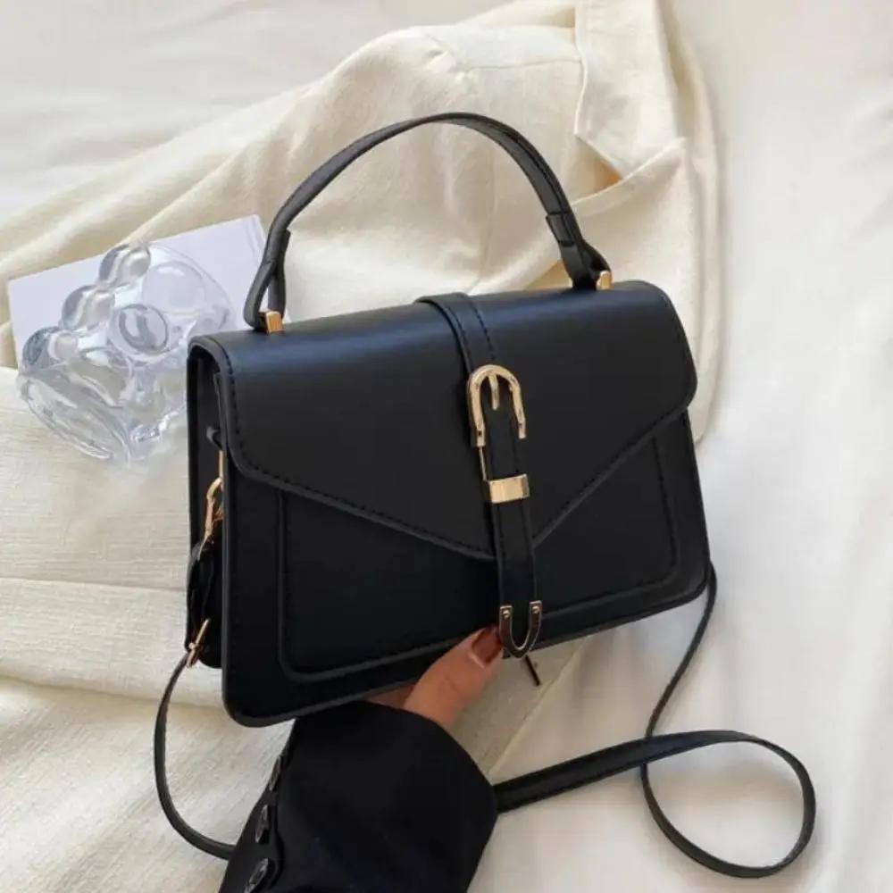 Sac à bandoulière Danoir Paris Tessa, élégant et minimaliste, en cuir noir avec finition sophistiquée, pour un style chic.