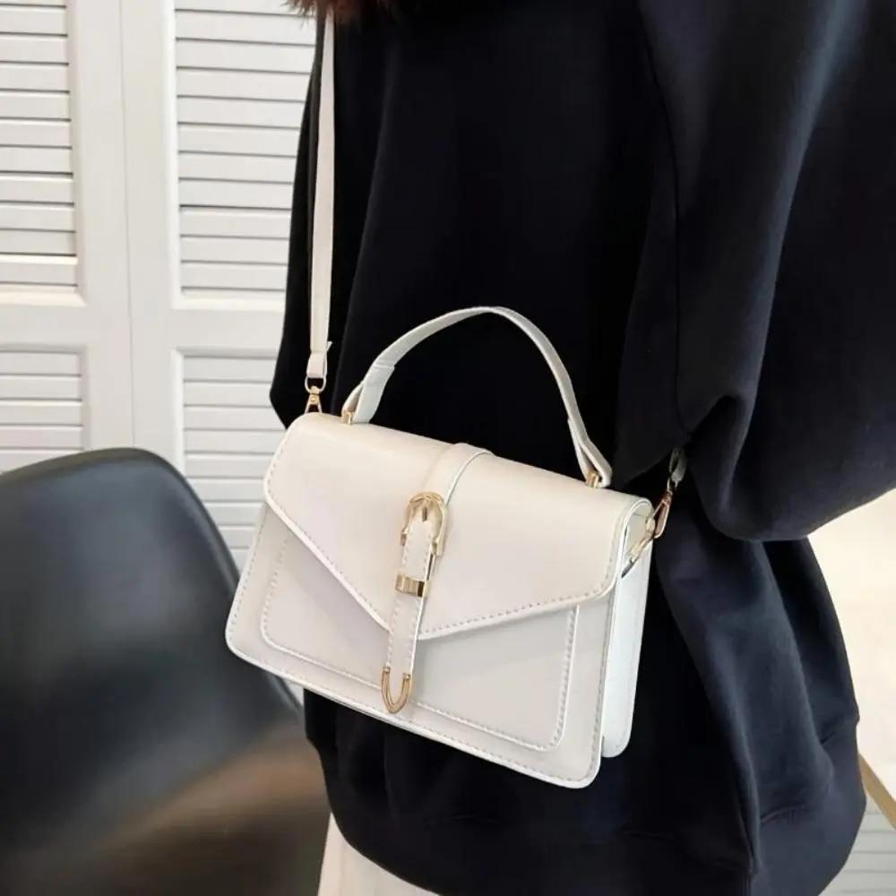 Sac à bandoulière Danoir Paris Tessa en cuir noir, design élégant et minimaliste, idéal pour une allure sophistiquée.