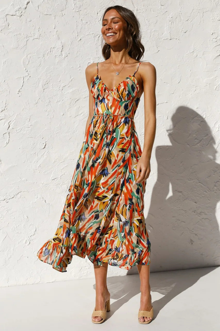 Robe fluide orange élégante de la marque Danoir Paris, vue de face avec détails de tissu léger et coupe sophistiquée.