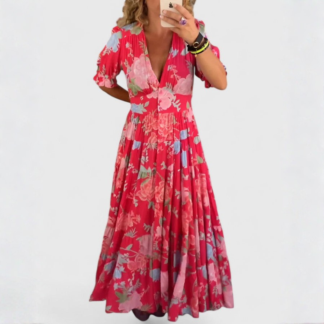 Robe fleurie Minelda de Danoir Paris avec col en V, tissu léger et coloré, portée par un mannequin debout.