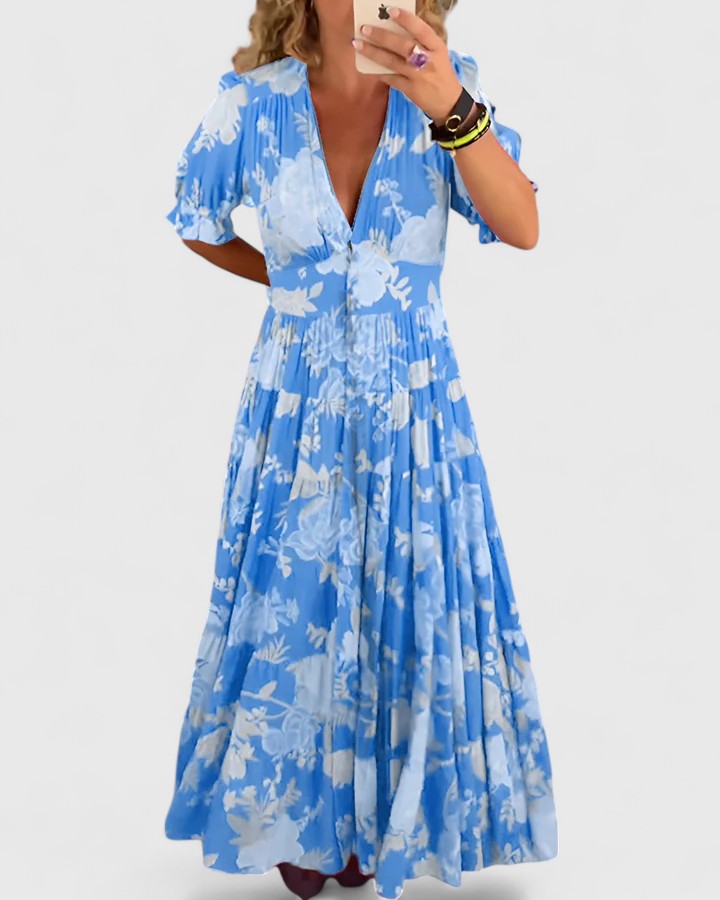 Robe fleurie Minelda Danoir Paris avec col en V, tissu léger rouge et motif floral, port de dos élégant.