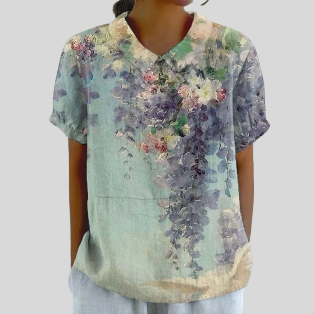 Blouse florale artistique Colette de Danoir Paris, tissu léger avec motifs floraux colorés, portée élégante et raffinée.