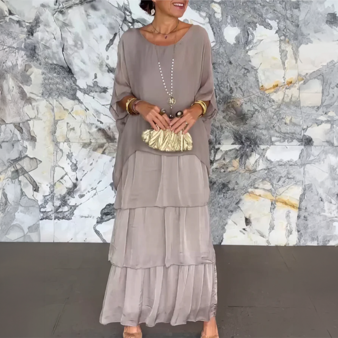 Robe longue fluide élégante Lara de Danoir Paris en tissu vert délavé, portée avec détails sophistiqués.