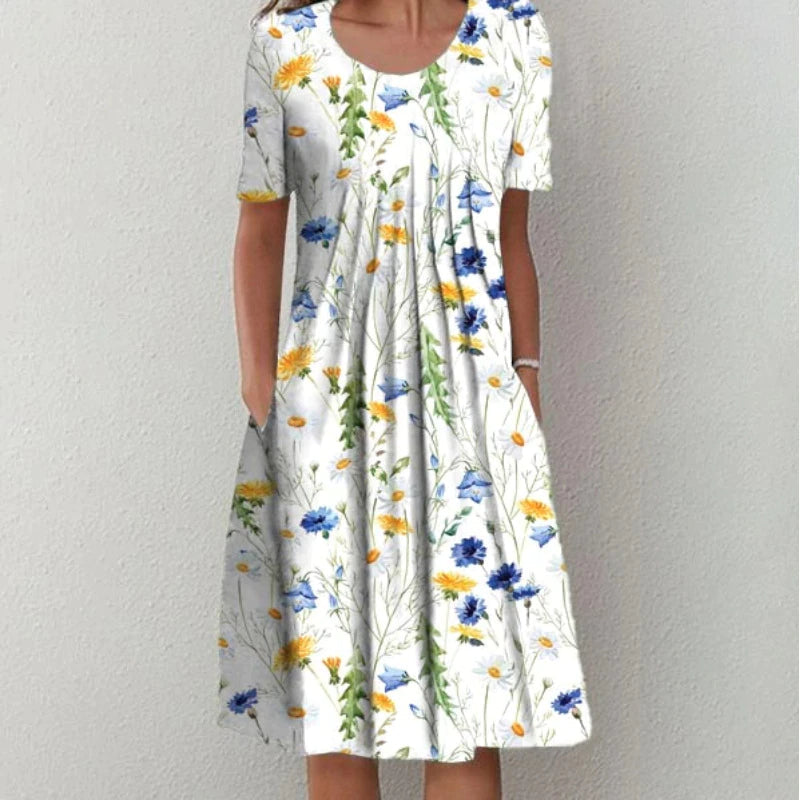 Robe midi aérée élégante pour femmes Danoir Paris, motif floral multicolore sur tissu blanc.