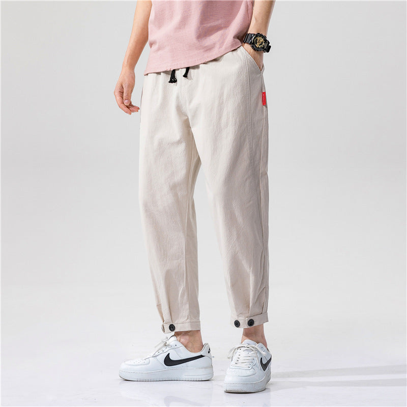 Pantalons ajustés en coton Theo de Danoir Paris, coupe moderne et tissu confortable, en bleu foncé.