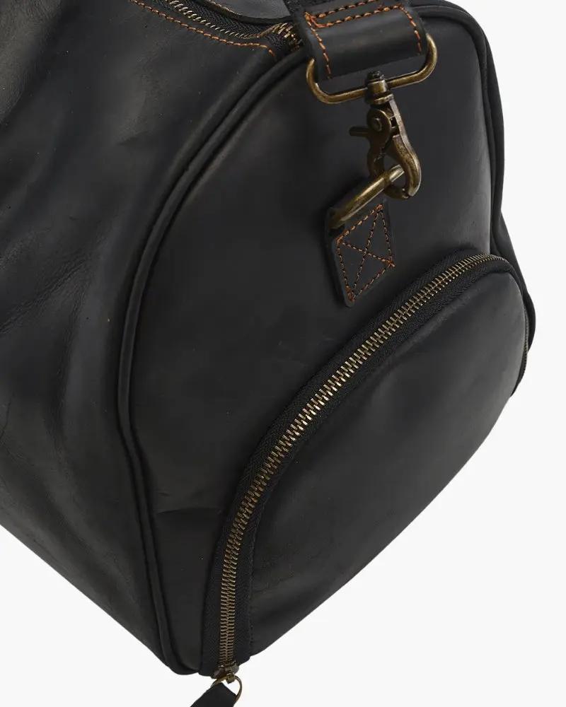Sac de voyage en cuir Montague de la marque Old Money, brun, avec poignées solides et fermeture zippée.