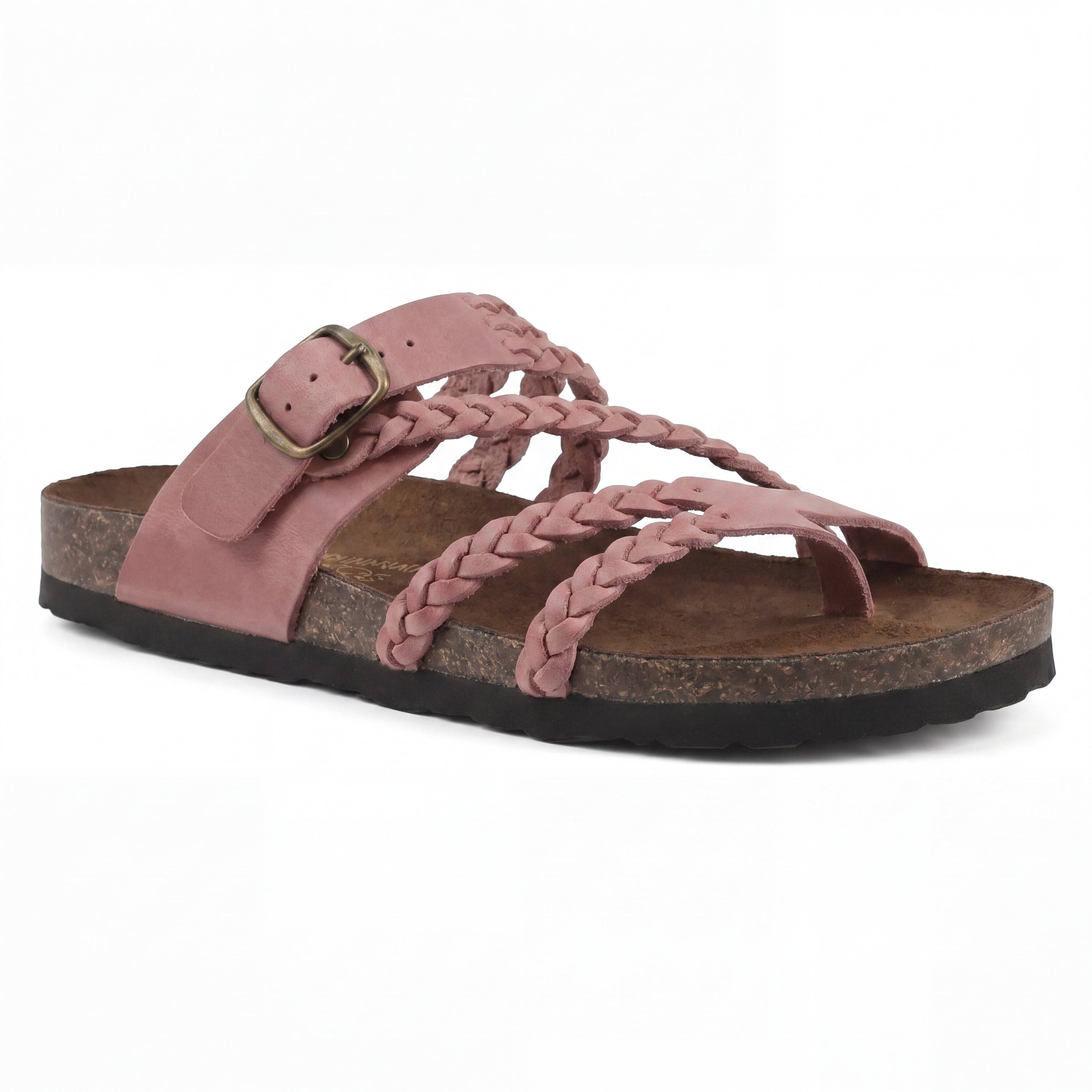 Sandales élégantes Danoir Paris en cuir avec brides tressées, roses en arrière-plan, style sophistiqué et féminin.