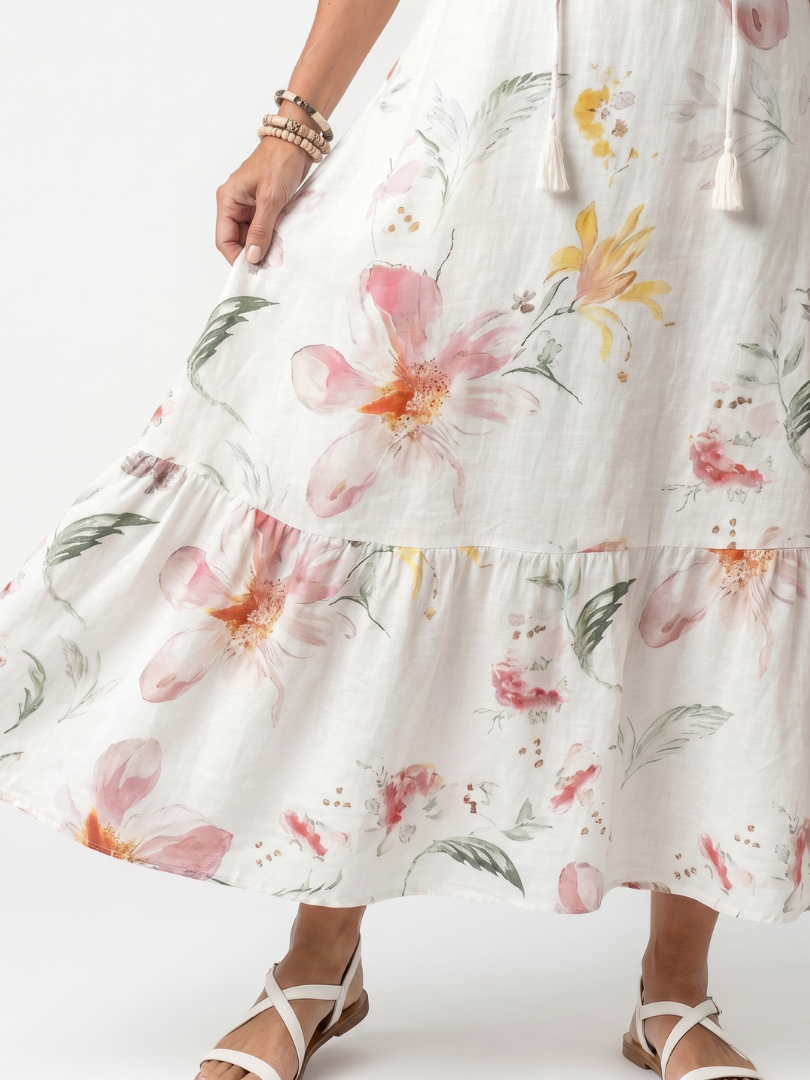 Robe midi florale douce Danoir Paris Noa avec volants et franges, tissu léger et motifs floraux élégants.