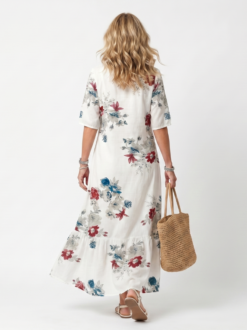 Robe midi à fleurs dispersées avec franges, style élégant, de la marque Danoir Paris, portée avec des détails floraux.