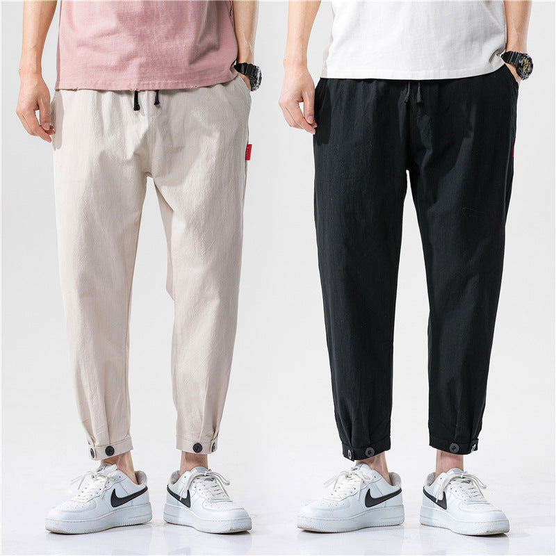 Pantalons ajustés en coton Theo de Danoir Paris, vue de face, en denim bleu avec poches et fermeture éclair, style moderne.