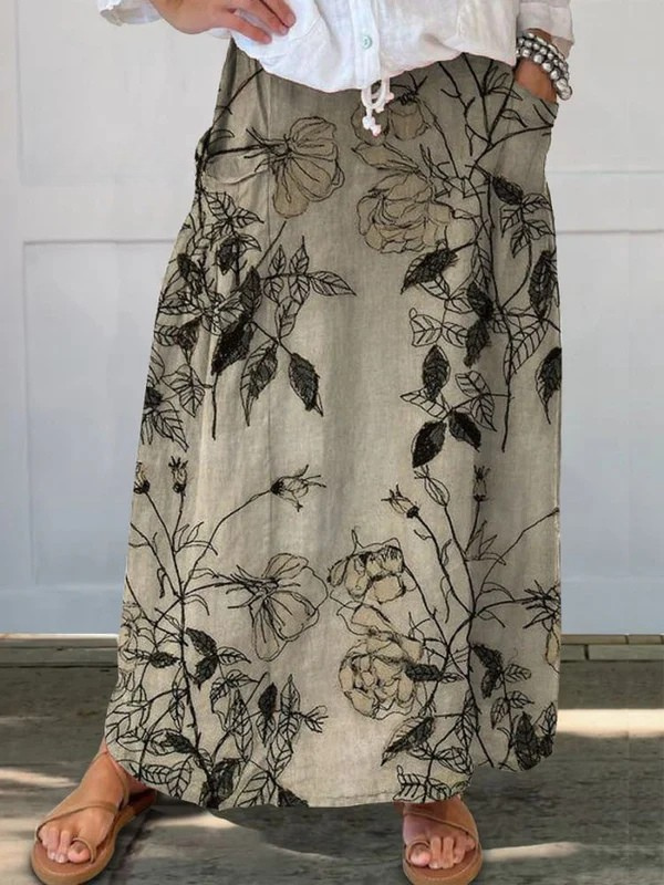 Jupe plissée à fleurs rétro Kisses™ de Danoir Paris avec taille élastique et poches, motif floral coloré, vue de face.