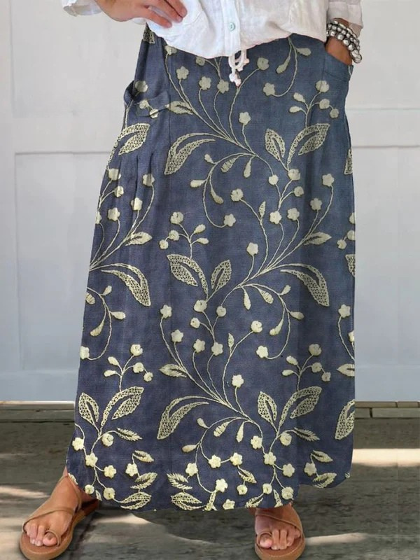Jupe portefeuille rétro florale Danoir Paris avec ceinture élastique et poches, design artistique et élégant.
