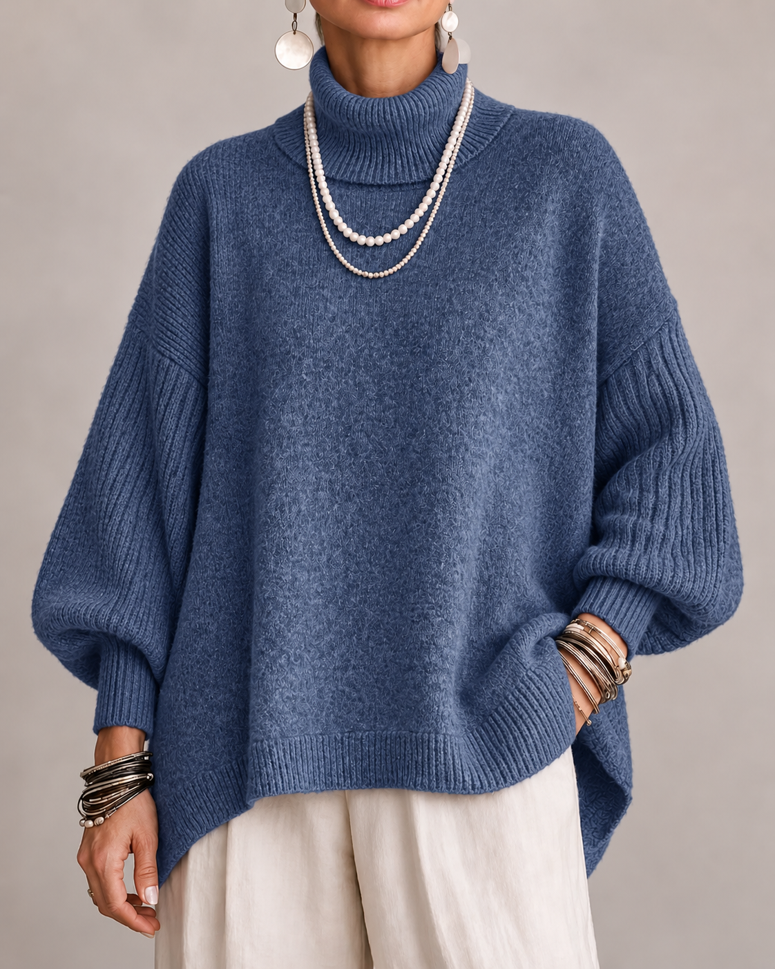 Pull élégant à col roulé Kathleen de Danoir Paris, en tissu doux, couleur neutre, porté sur mannequin avec détails du col.