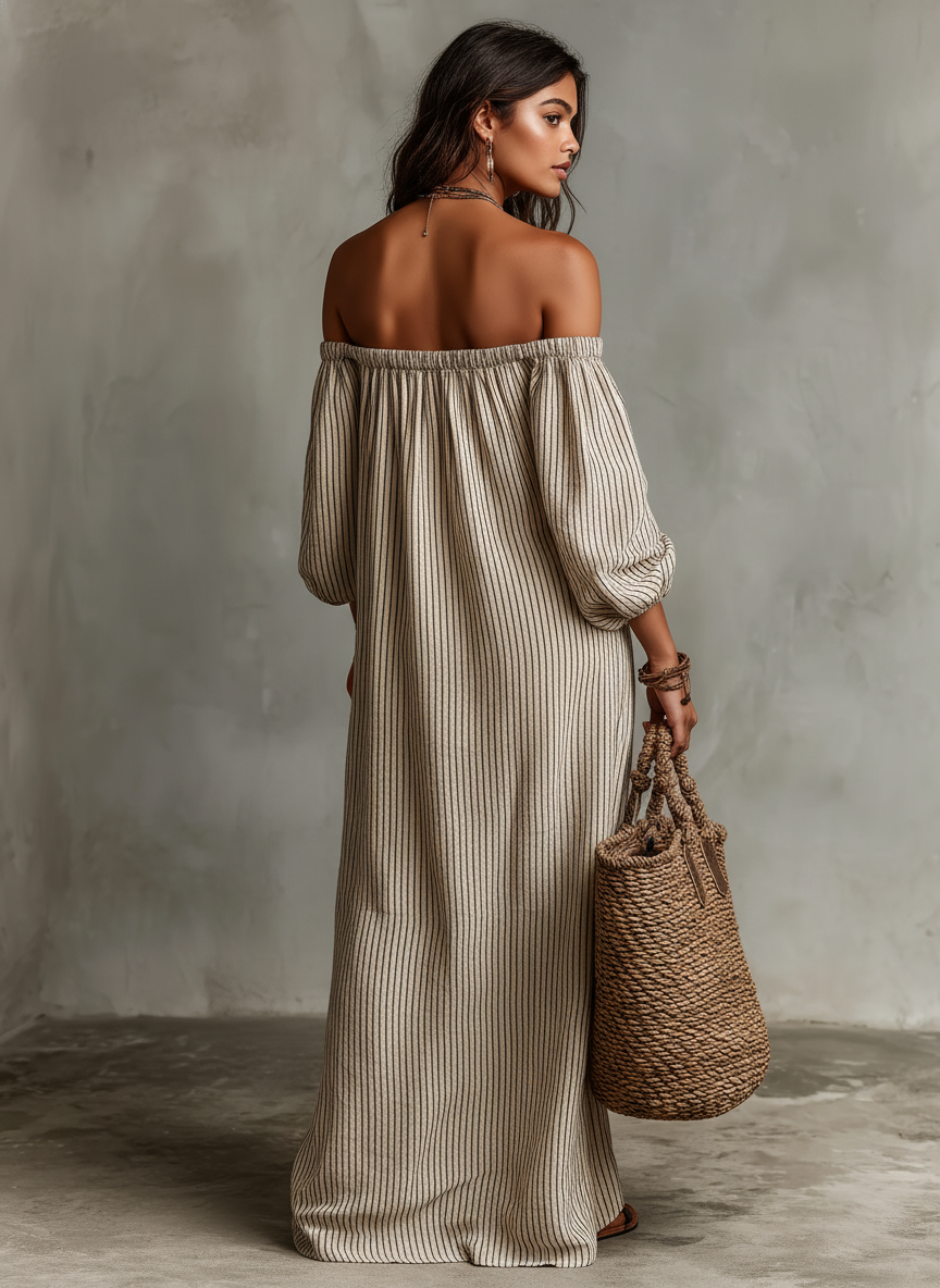 Robe longue beige à rayures avec épaules dégagées, style Carmen, de la marque Danoir Paris, portée élégamment.