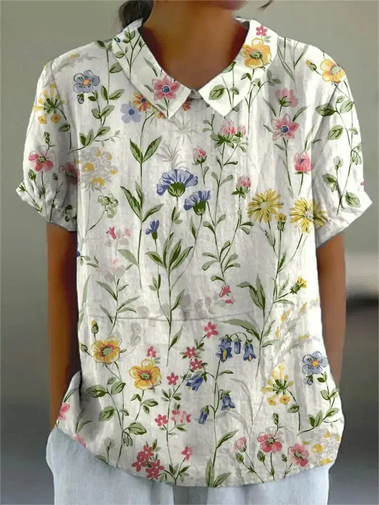 Chemise fleurie élégante Sofia de Danoir Paris, tissu blanc à motifs floraux, vue de face sur mannequin.