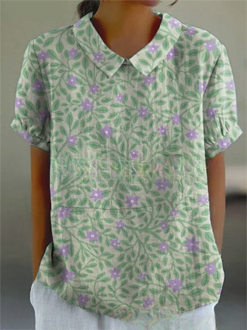 Chemise fleurie élégante Sofia de Danoir Paris avec motif floral blanc, tissu léger et coupe sophistiquée.