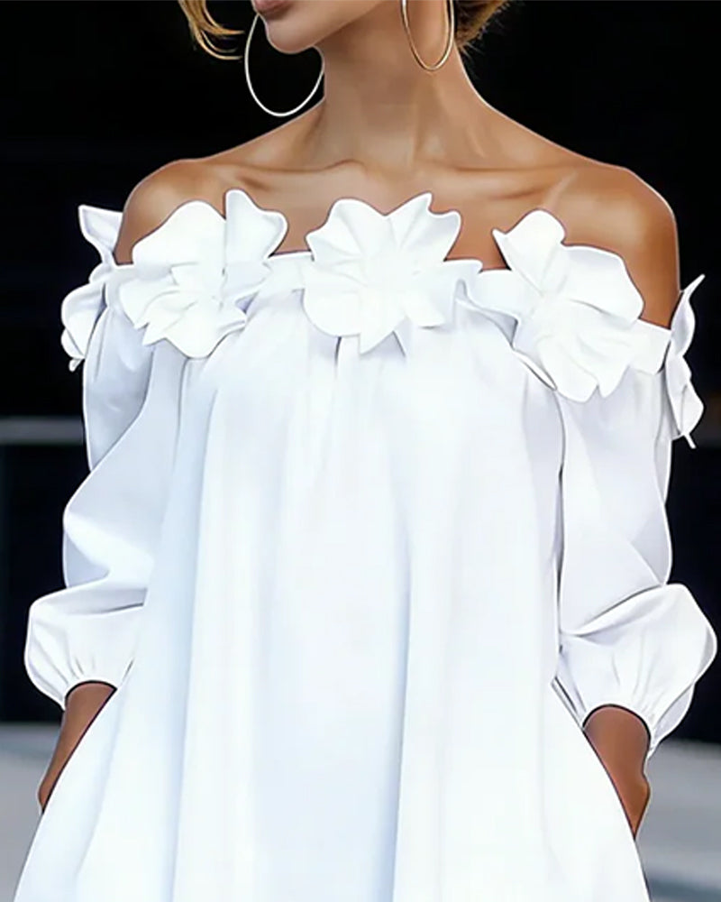 Robe à bretelles dénudées avec appliqué floral de la marque Danoir Paris, en tissu blanc élégant.