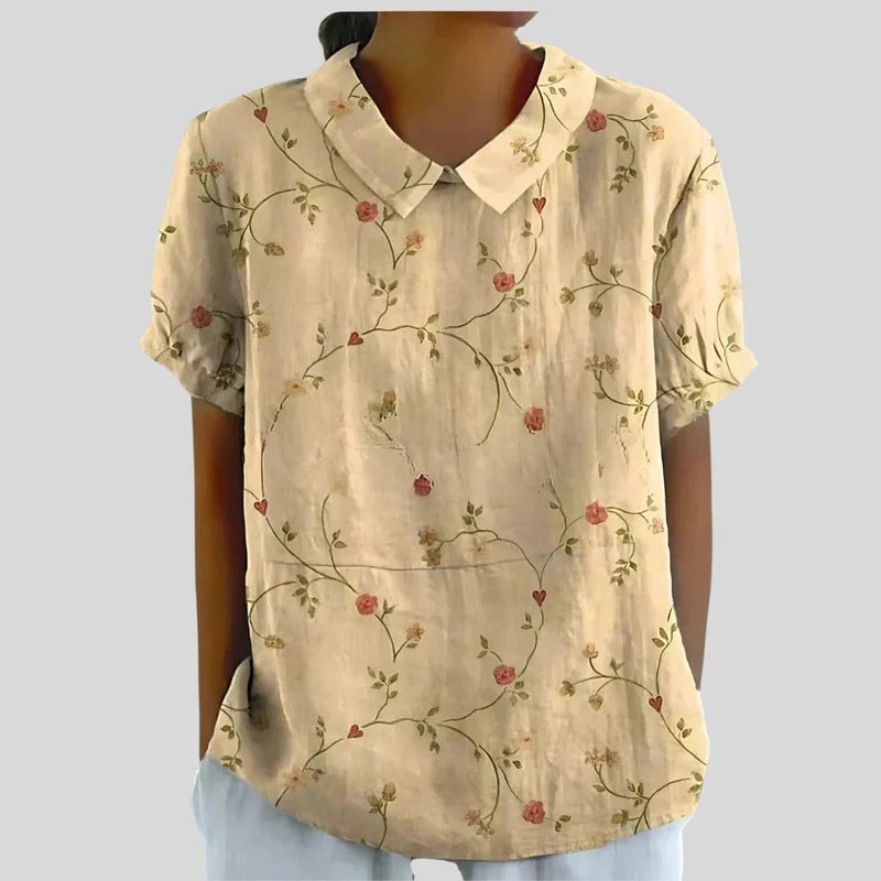 Blouse Clarélia™ Danoir Paris avec motifs floraux délicats, tissu blanc léger et style élégant, vue de face.