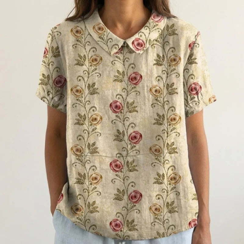 Blouse Clarélia™ Danoir Paris à fleurs délicates en tissu blanc, style élégant avec motif floral léger.