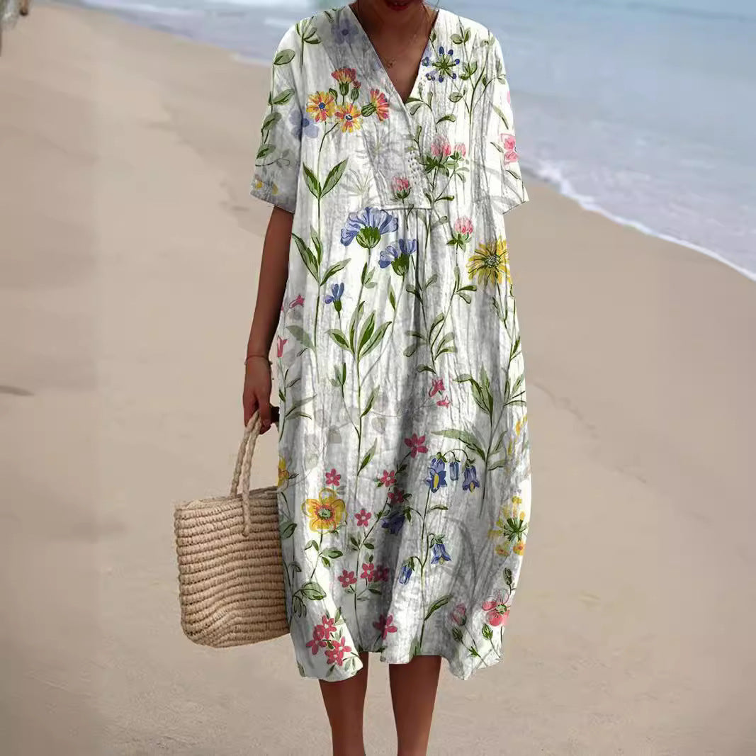 Robe florale éclatante Nicka de Danoir Paris avec motif coloré et détails élégants, vue de face sur fond neutre.