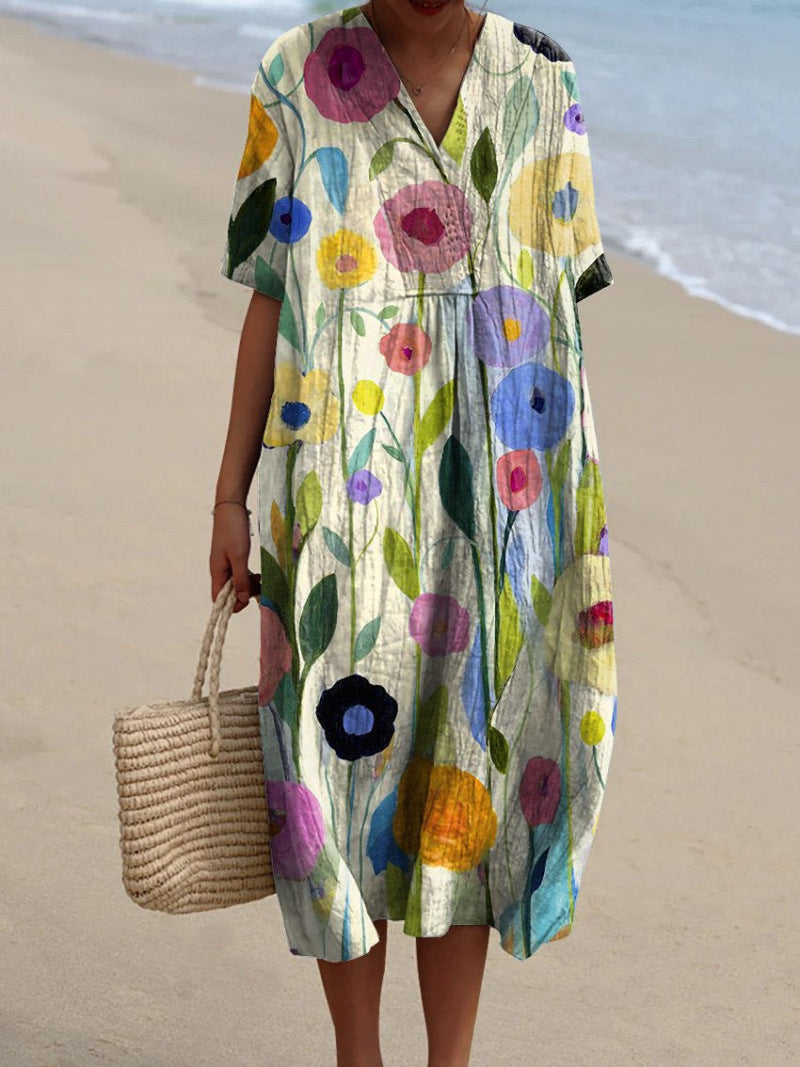 Robe florale éclatante Nicka de Danoir Paris avec motifs colorés, tissu léger et style élégant pour femme.