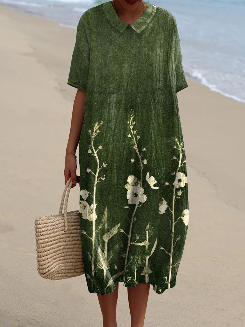 Robe florale éclatante Nicka de Danoir Paris, tissu léger avec imprimé floral coloré, portée élégante pour occasions spéciales.