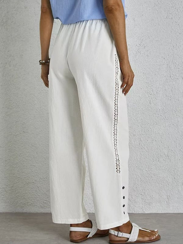 Pantalons relaxés blancs Danoir Paris Shania avec boutons, pièce tendance en vente, vue de face.