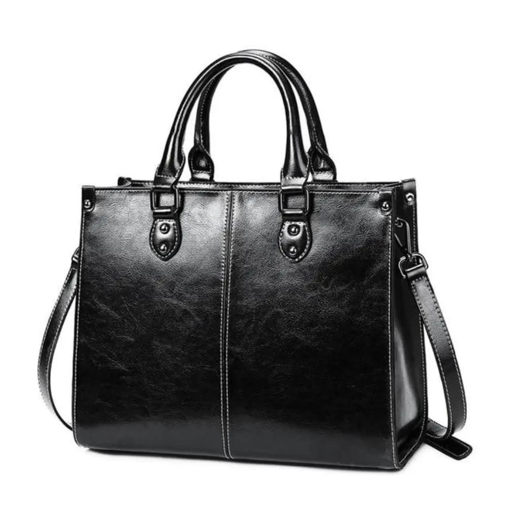 Sac à main Danoir Paris Seraphina en cuir cognac, design élégant et pratique, avec poignées et détails sophistiqués.