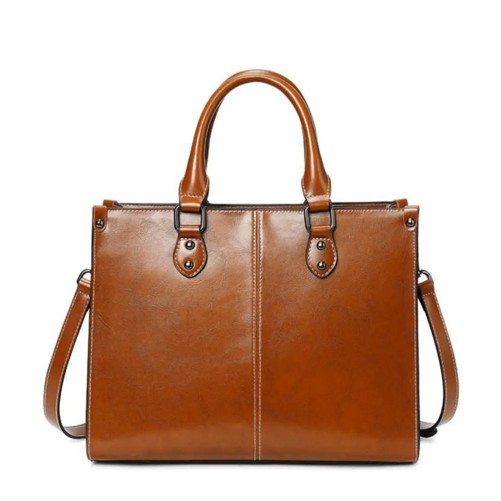 Sac à main Danoir Paris Seraphina en cuir cognac, avec poignées élégantes et détails raffinés pour un look intemporel.