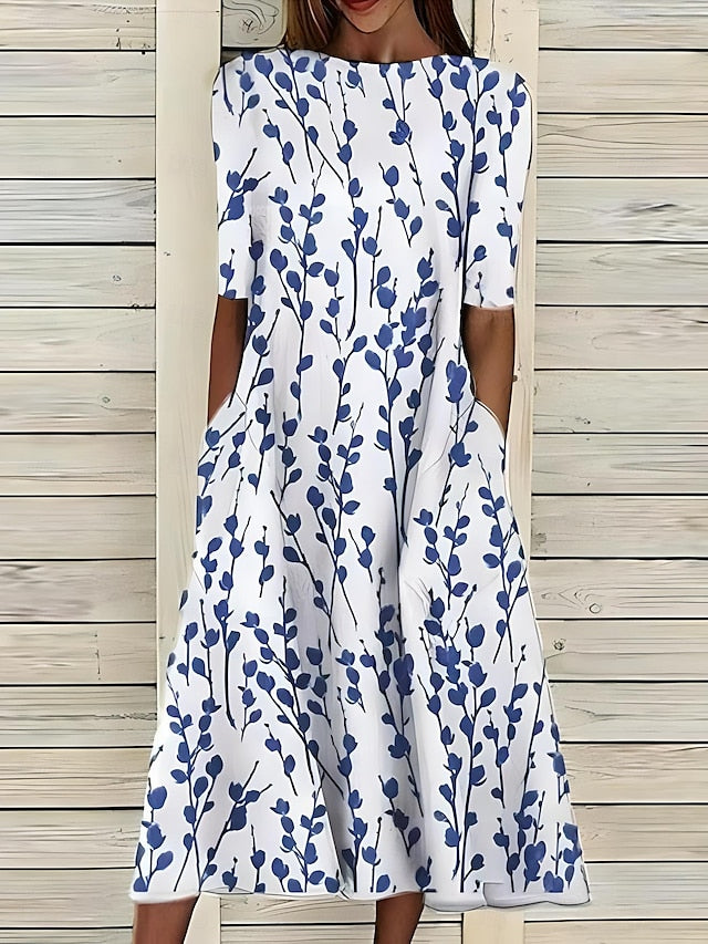 Robe d'été élégante Danoir Paris en tissu bleu, coupe fluide et style sophistiqué, parfaite pour les journées chaudes.