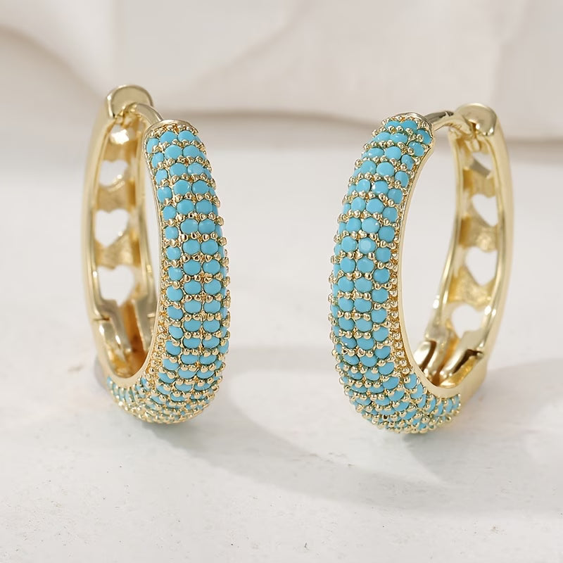 Boucles d'oreilles turquoise charmantes de Danoir Paris, en pierre colorée, suspendues avec détails élégants.