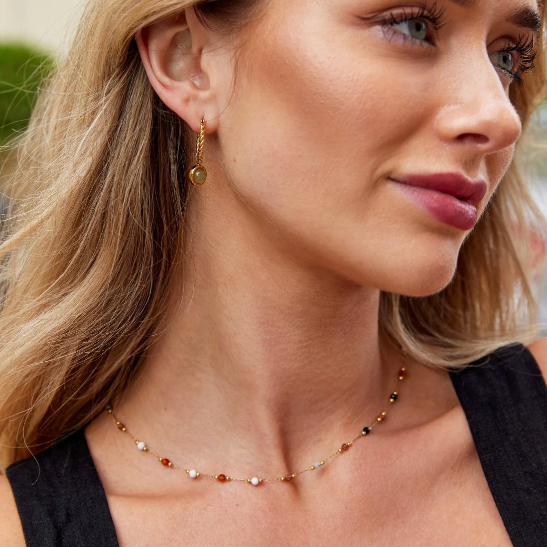 Collier minimaliste avec pierre de Danoir Paris, chaîne fine avec pendentif en pierre colorée, porté sur un fond clair.