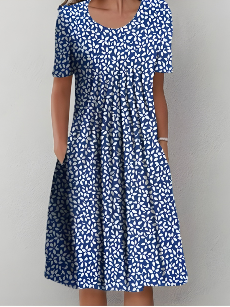 Robe plissée florale Cäcilia de Danoir Paris avec motif de fleurs rouges sur fond blanc, taille XS.